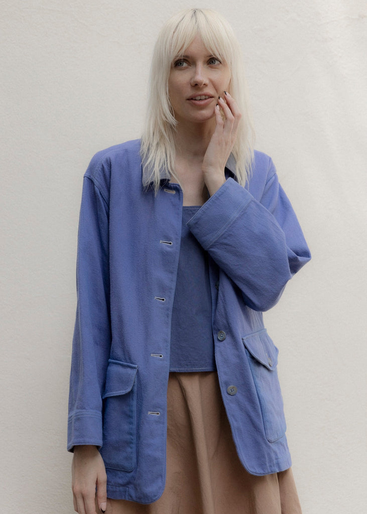 Woman wearing a blue jacket against a plain background